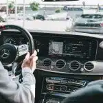 person in gray long sleeve shirt driving car