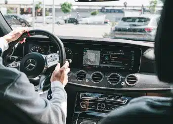 person in gray long sleeve shirt driving car